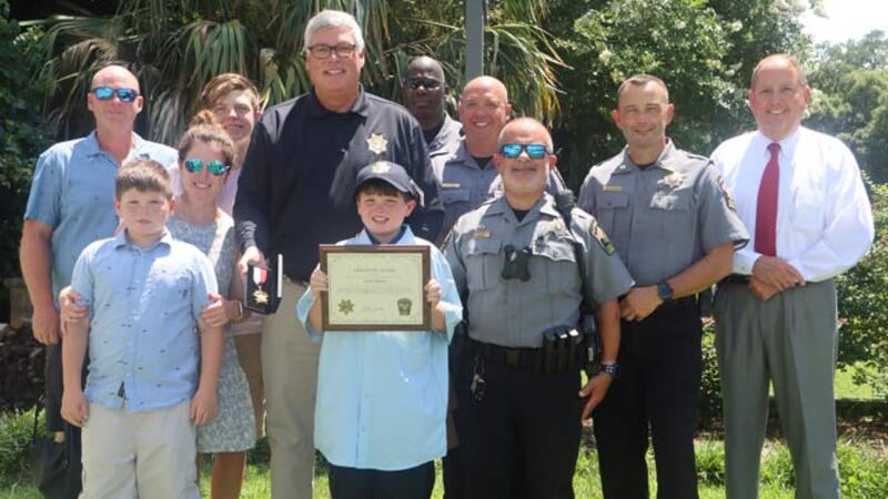 Georgetown County Sheriff Carter Weaver visited the home of 12-year-old Jack Olsen to...