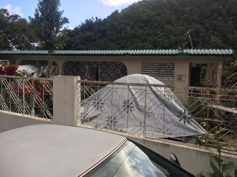 A tent has been set up amidst the homes damaged by earthquakes in Puerto Rico.
