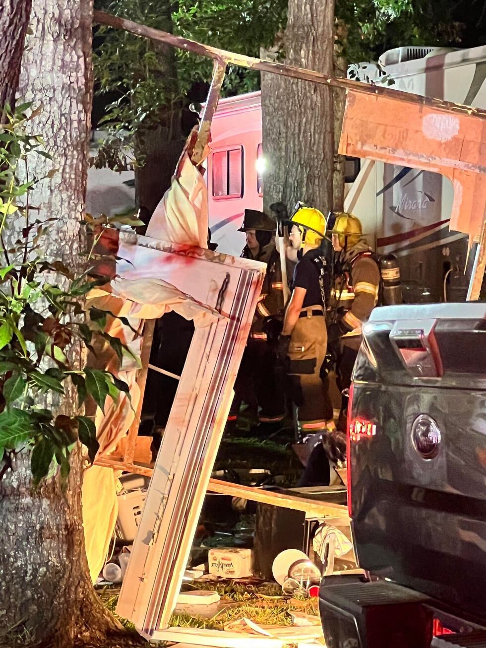 Firefighter on the scene look over at the wreckage