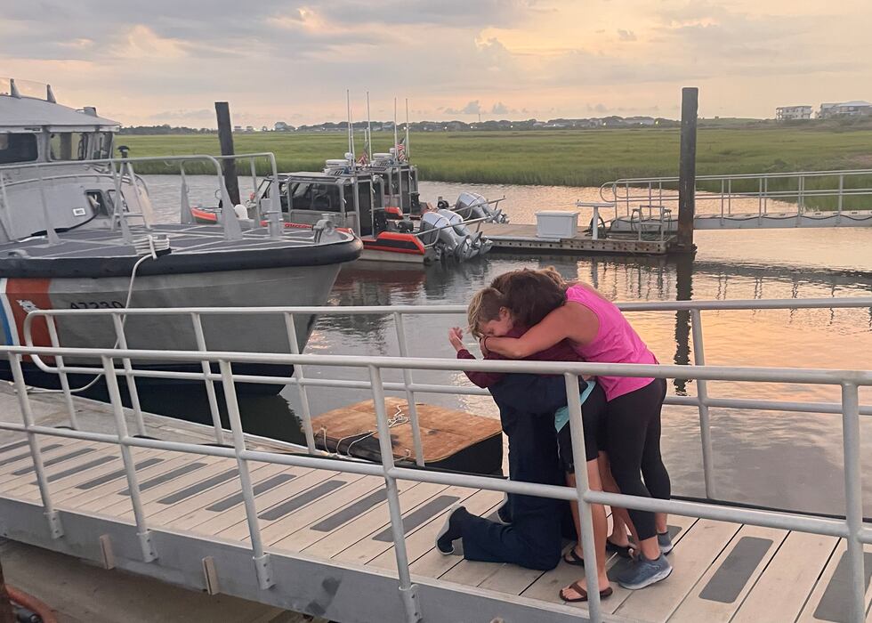 One of the divers being embraced by loved ones after the successful rescue