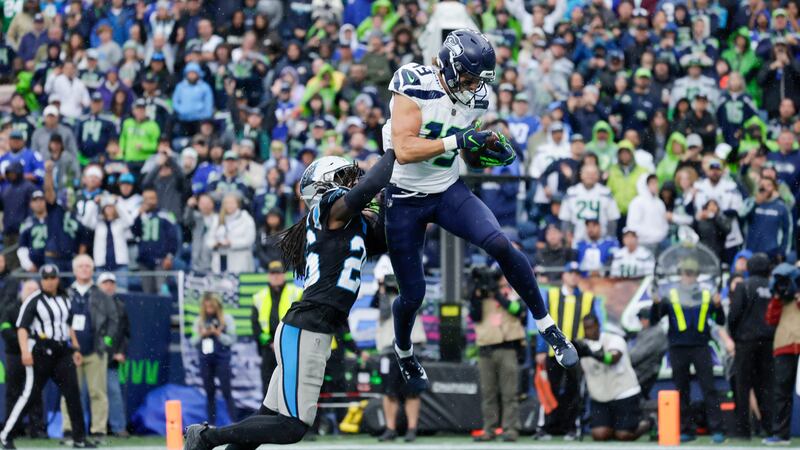 Seattle Seahawks wide receiver Jake Bobo catches a touchdown pass over Carolina Panthers...
