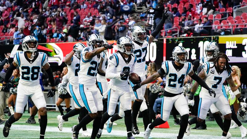 The Carolina Panthers celebrate during the second half of an NFL football game against the...