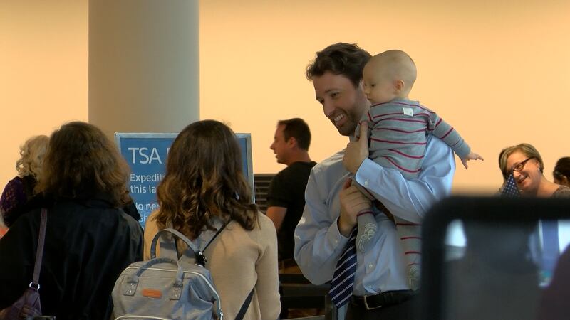 Congressman-elect Joe Cunningham with son Boone in arms heads through security at the...