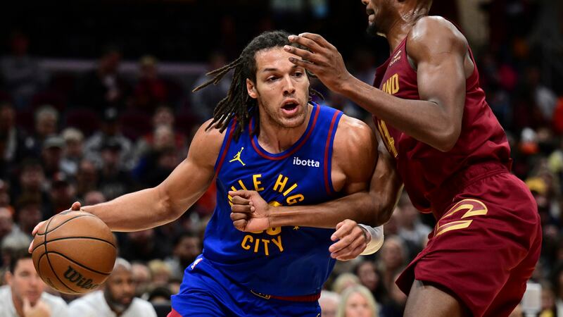 Denver Nuggets forward Aaron Gordon, left, drives on Cleveland Cavaliers forward Evan Mobley...