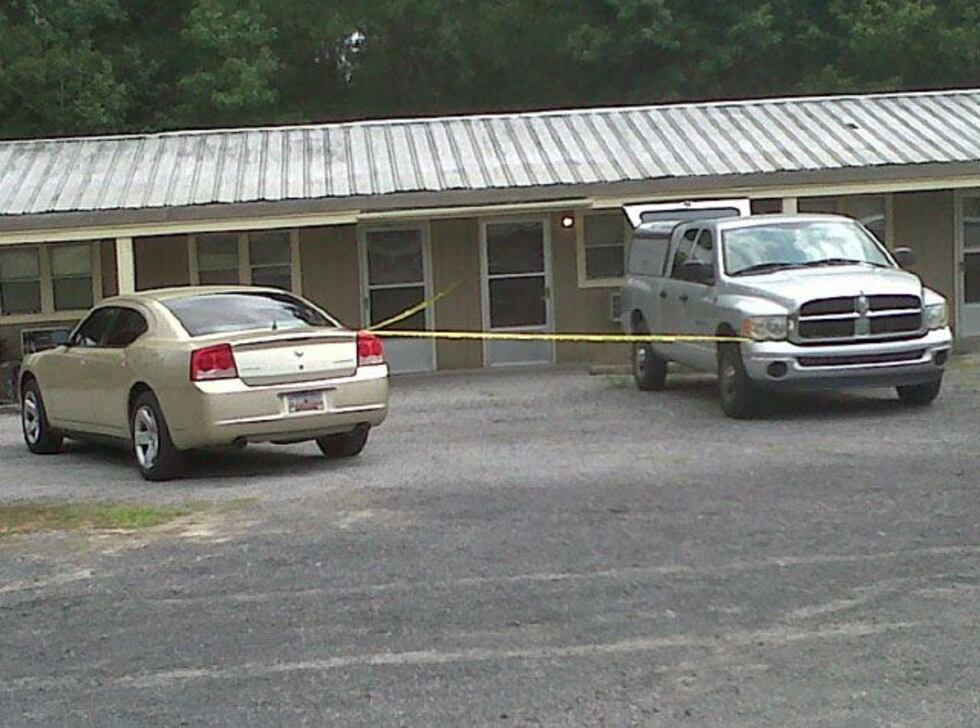 Crime scene tape has been placed across the outside entrances of a few hotel rooms. (Source:...