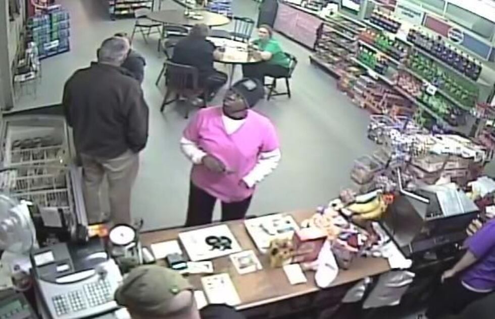 Authorities say woman in pink shirt is a person of interest. (SCHP)