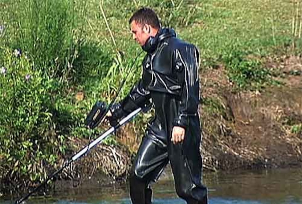 Crews search for clues in a pond Tuesday morning.