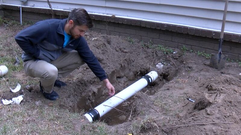 Chad Brandenburg inspects the sewer and fiber optic lines in his James Island backyard.